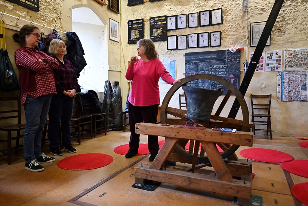 Kate Flavell (right) teaches Charlotte Mafi (second left) and Anne Porter (second right) during a bell ringing training session at All Saints Church, in Kingston-upon-Thames, in southwest London. — AFP photos
