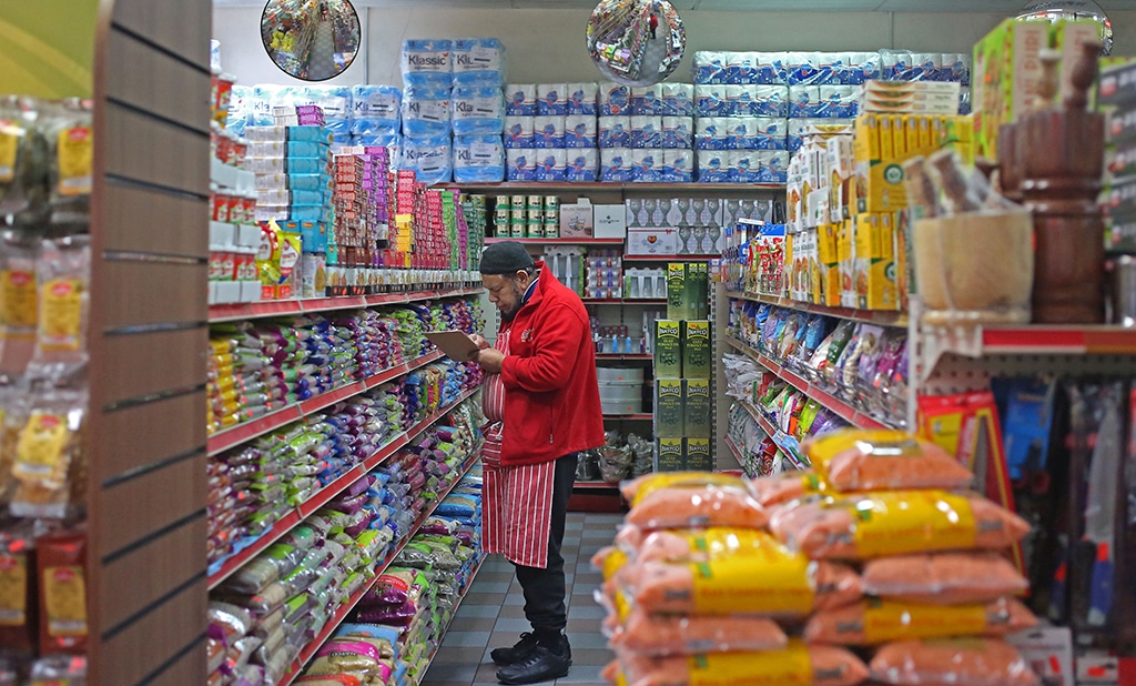 LONDON: A worker checks the stock inside Taj Stores in east London. Ramadan, which is celebrated globally and by the nearly 4 million Muslims in England and Wales, is affected by inflation in the UK hovering above 10 percent. – AFP