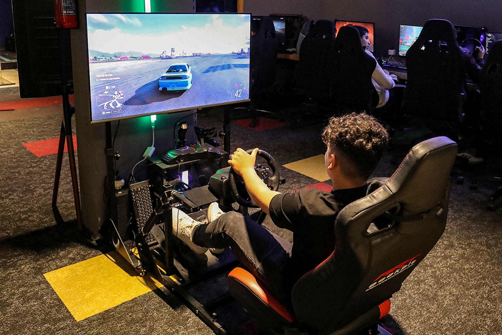 In this picture a youth plays an electronic auto sports game on a dedicated car simulator at a video gaming centre in Libya's capital Tripoli.