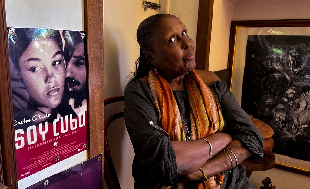 Cuban actress Luz Maria Collazo gestures next to a poster of the Russian-Cuban film (Soy Cuba)(I Am Cuba) in which she starred, during an interview with AFP at her flat in Nuevo Vedado, in Havana.--AFP photos