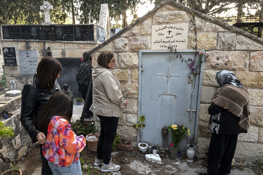 IQRIT: Christian believers visit a grave at the cemetery of the Palestinian village of Iqrit, on April 7, 2023. – AFP