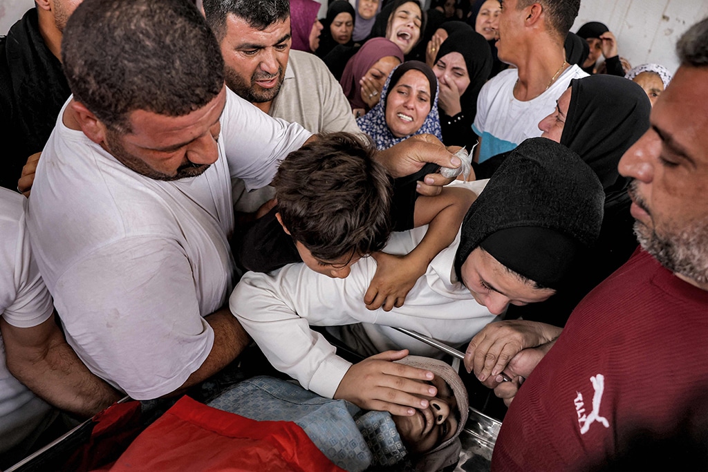 AQABAT JABER CAMP: Family members of Palestinian teenager Mohammed Fayez Balhan, 15, mourn by his body at their family home near Jericho in the occupied West Bank on April 10, 2023, after he was killed during a Zionist raid. – AFP