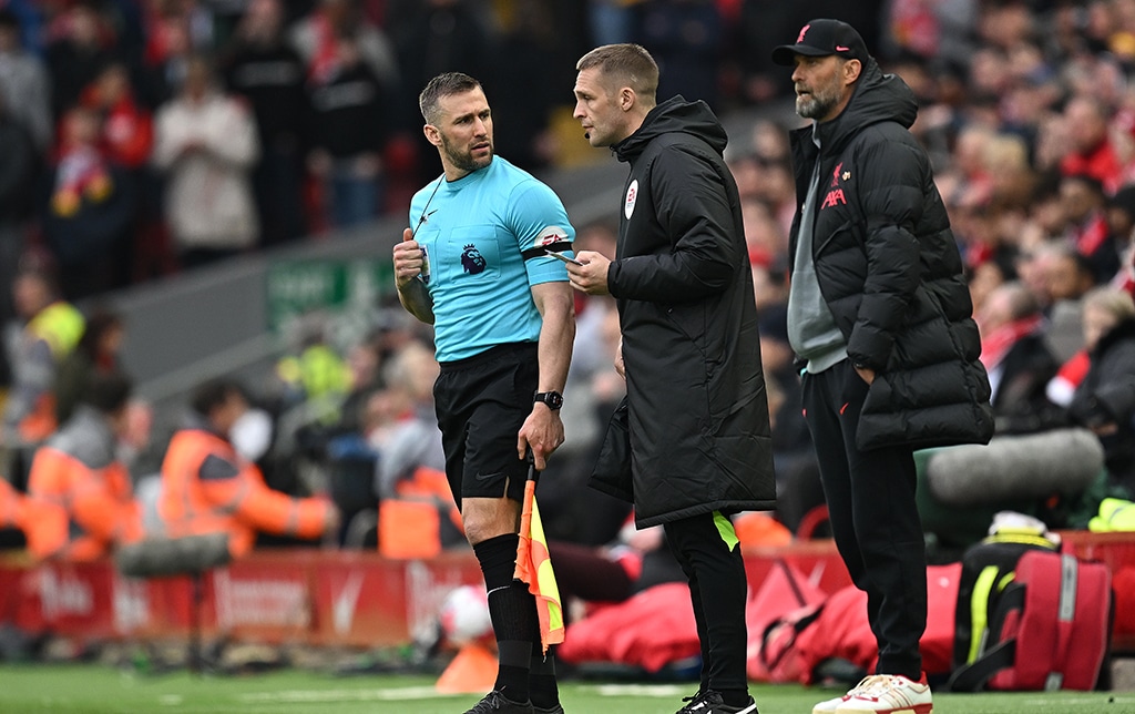 LIVERPOOL: Liverpool’s German manager Jurgen Klopp (right) looks on as Fourth Official Craig Pawson (center) talks to assistant referee and linesman Assistant Referee Constantine Hatzidakis during the English Premier League football match between Liverpool and Arsenal at Anfield in Liverpool.- AFP