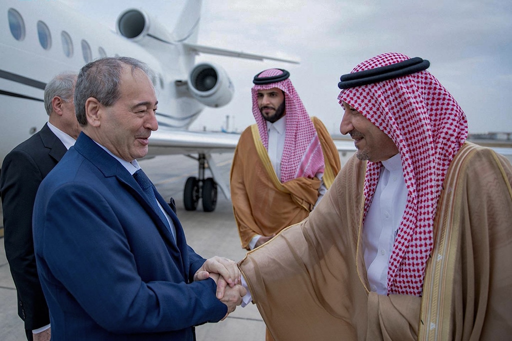 JEDDAH: A handout picture provided by the Saudi Press Agency (SPA) shows Saudi Deputy Foreign Minister Walid Al-Khuraiji (right) receiving Syrian Foreign Minister Faisal Mekdad (left) upon his arrival at the airport of Jeddah. — AFP