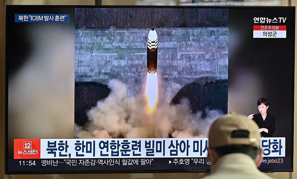 SEOUL: A man watches a television news screen showing a picture of North Korea's recent test-firing of a Hwasong-17 intercontinental ballistic missile (ICBM), at a railway station on March 17, 2023. - AFP