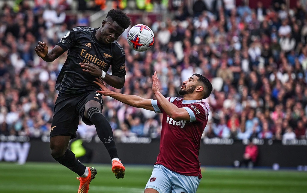 LONDON: Arsenal's English midfielder Bukayo Saka fights for the ball with West Ham United's Algerian midfielder Said Benrahma at the London Stadium on April 16, 2023. – AFP