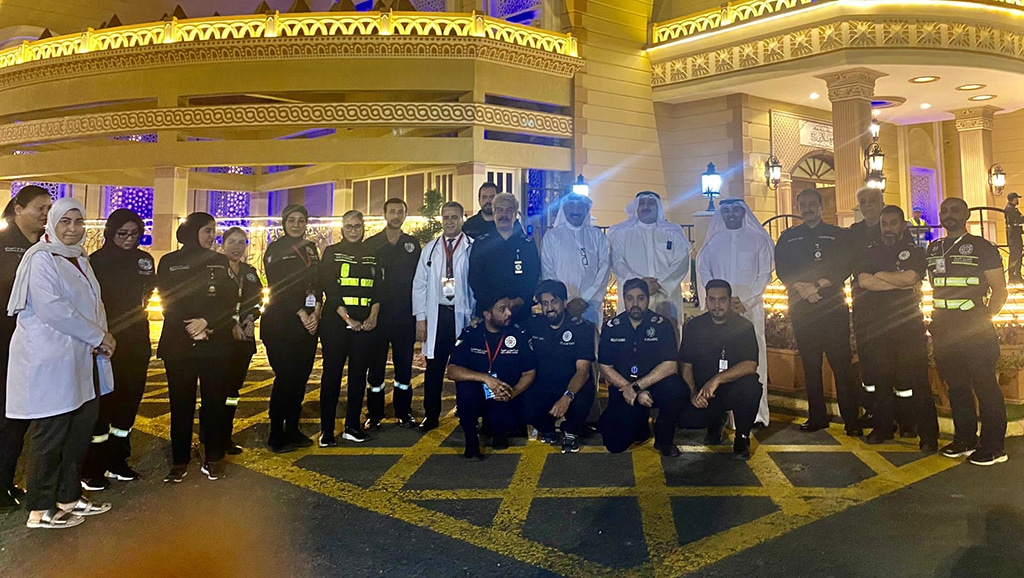 The minister of health poses with officials and paramedics during his tour to Bilal bin Rabah Mosque.