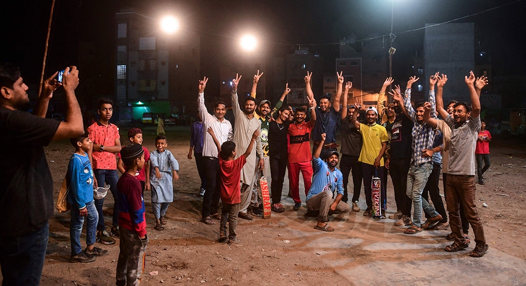 In this picture young cricketers pose for a photograph after winning a tape ball night cricket match during the Muslim holy fasting month of Ramadan in Karachi. —AFP photos