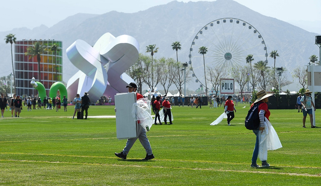 Workers pick up trash on the grounds during the first week of the Coachella Valley Music and Arts Festival.— AFP photos