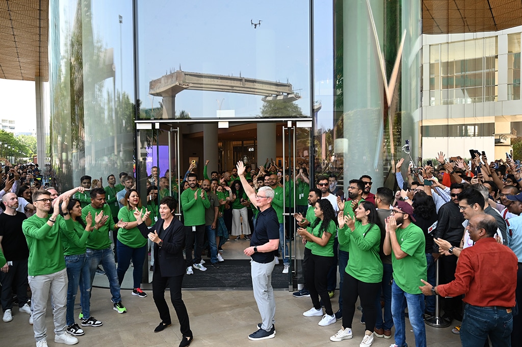 MUMBAI, India: Chief Executive Officer of Apple Tim Cook (center right) waves during the opening of Apple's first retail store in India, in Mumbai on April 18, 2023. -- AFP