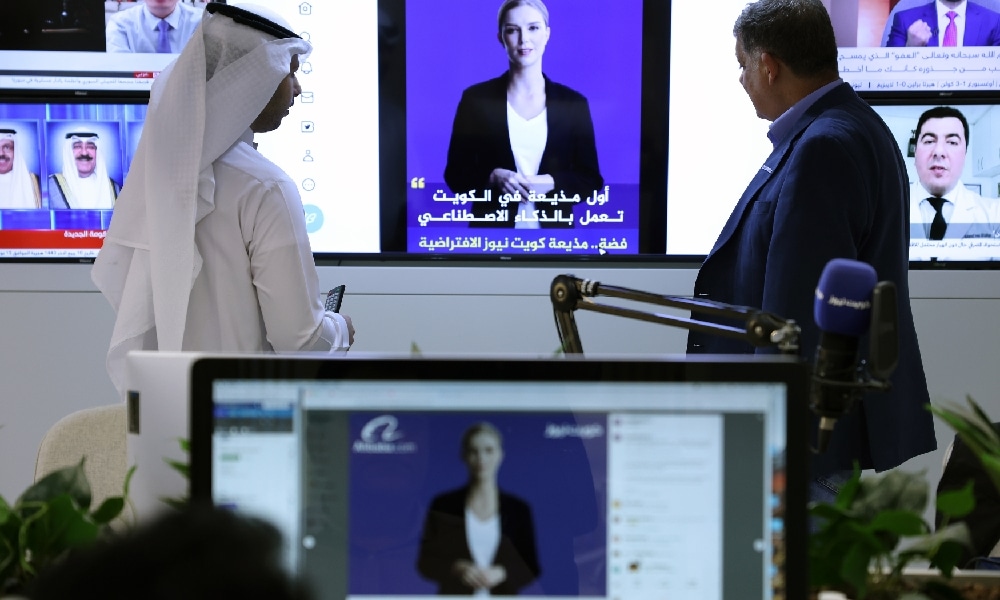KUWAIT: Journalists watch an introductory video by the 'artificial intelligence' anchor Fedha on the twitter account of Kuwait News service, in Kuwait City on April 9, 2023. - AFP 