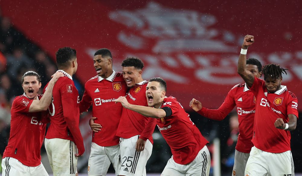 Manchester United players celebrate after winning a penalty shoot out during the English FA Cup semi-final football match between Manchester United and Brighton and Hove Albion at Wembley Stadium in north west London on April 23, 2023. - AFP