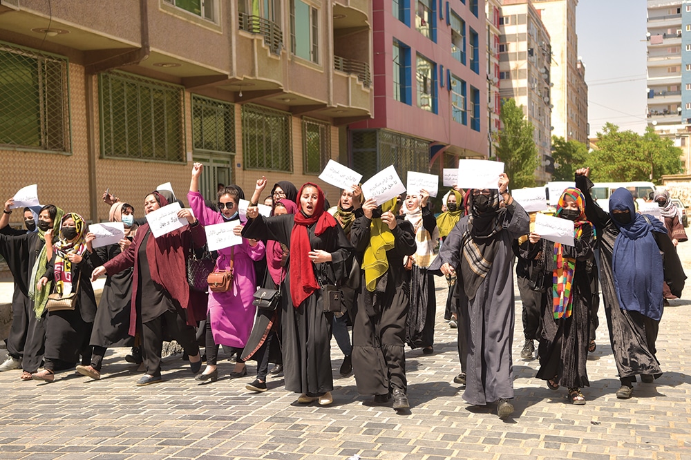 KABUL: Afghan women hold placards as they march to protest for their rights, in Kabul on April 29, 2023. – AFP