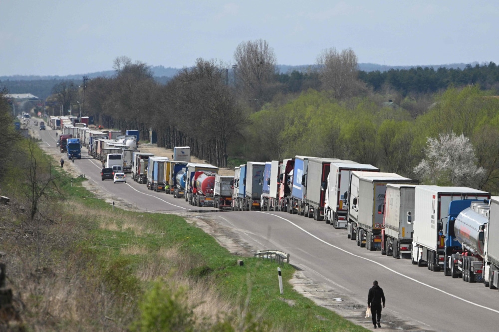 Truck drivers queue on over ten kilometers at the Rava-Ruska border checkpoint on the Ukrainian-Polish border, on April 18, 2023. — AFP