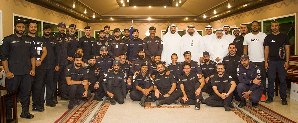 Ahmed Al-Amir and Rear Admiral Talal Al-Mounas pose for a group photo with members of the Coast Guard and bank’s team.