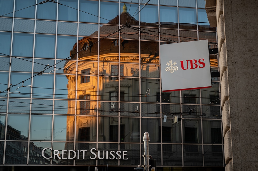 BASEL: A sign of Swiss bank giant UBS bank is seen next to a sign of Credit Suisse baking in Basel, on April 4, 2023. —AFP