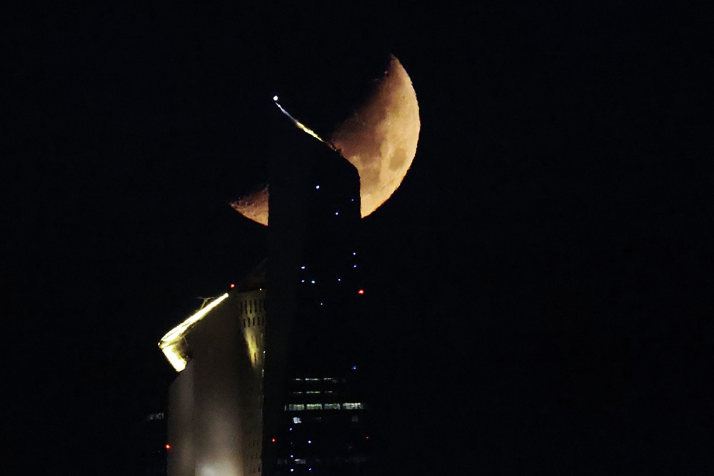 KUWAIT: The waxing crescent moon sets behind the Al-Hamra tower in Kuwait City early on April 27, 2023. — Photo by Yasser Al-Zayyat
