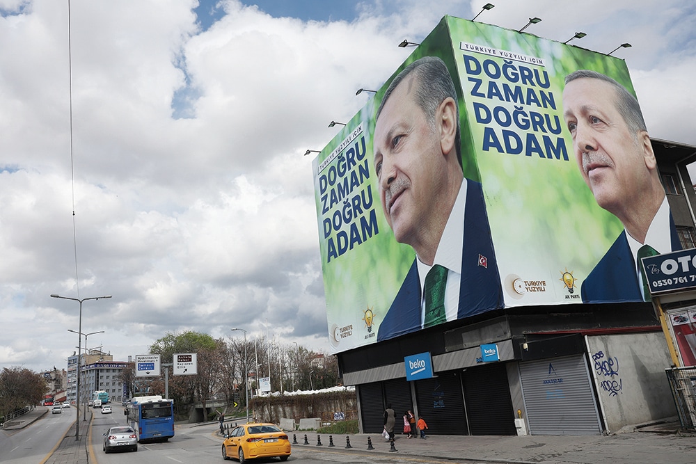 ANKARA: Pedestrians walk past billboards showing the portrait of Turkish President Tayyip Erdogan and a slogan reading 'For Turkey's century; the right time, the right man' on a building ahead of the May 14 presidential and parliamentary elections, in Ankara. – AFP