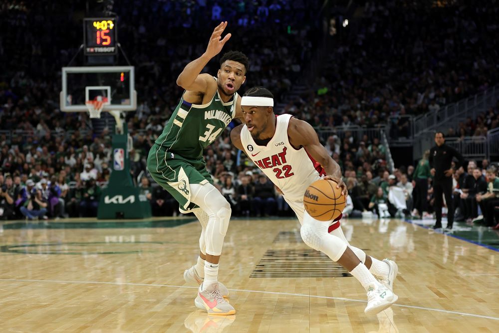 MILWAUKEE: Jimmy Butler #22 of the Miami Heat drives around Giannis Antetokounmpo #34 of the Milwaukee Bucks during the second half of Game 5 of the Eastern Conference First Round Playoffs at Fiserv Forum on April 26, 2023 in Milwaukee, Wisconsin. - AFP