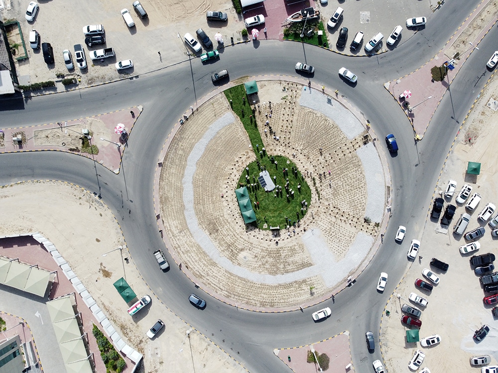 KUWAIT: An aerial view shows people planting trees at a roundabout in Mesayel on April 29, 2023, as part of a afforestation campaign. — Photos by Yasser Al-Zayyat