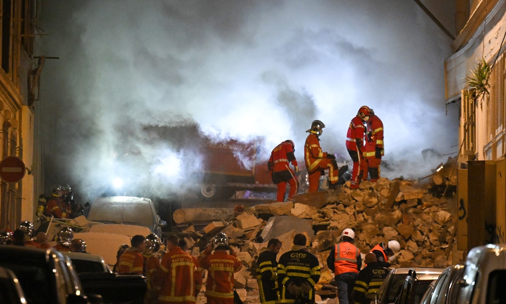 escue personnel work at the scene where a building collapsed in the southern French port city of Marseille early on April 9, 2023.
