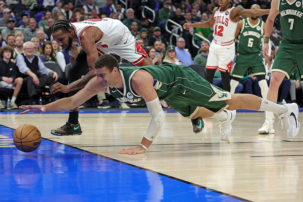 MILWAUKEE: Brook Lopez #11 of the Milwaukee Bucks and Derrick Jones Jr. #5 of the Chicago Bulls dive for a loose ball during the second half of a game at Fiserv Forum on April 05, 2023 in Milwaukee, Wisconsin.— AFP