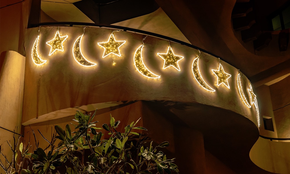 The lighted chain of crescents and stars adorn house