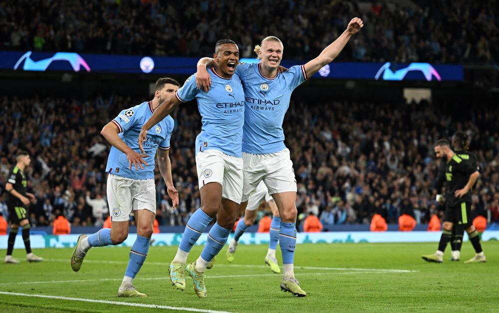 MANCHESTER: Manchester City's Swiss defender Manuel Akanji (L) celebrates scoring the team's third goal with Manchester City's Norwegian striker Erling Haaland during the UEFA Champions League second leg semi-final football match between Manchester City and Real Madrid at the Etihad Stadium in Manchester, north west England, on May 17, 2023. - AFP