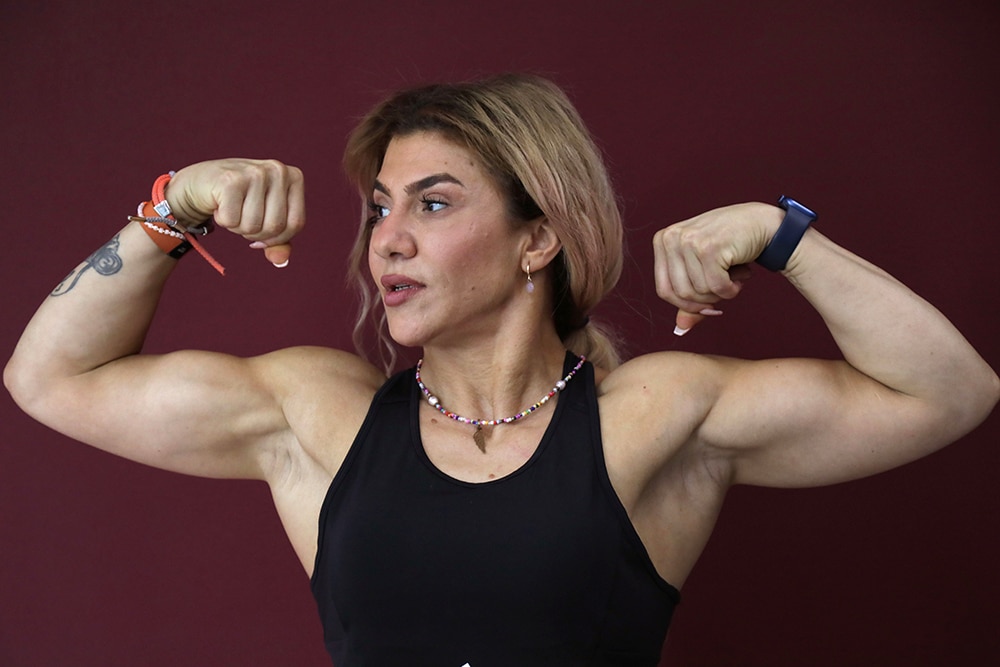In this picture taken on April 27, 2023, Iraqi Kurd Shylan Kamal poses for a picture at a gym in Arbil, the capital of the autonomous Kurdish region of northern Iraq. - As a young girl, Shylan would help her mother knead bread until one day she realised the work was a way to build up muscles -- and she liked it. Now 46 and herself a mother to three adult children, Kamal sees her passion for bodybuilding as a matter of gender equality in Iraq's autonomous Kurdistan region. —AFP