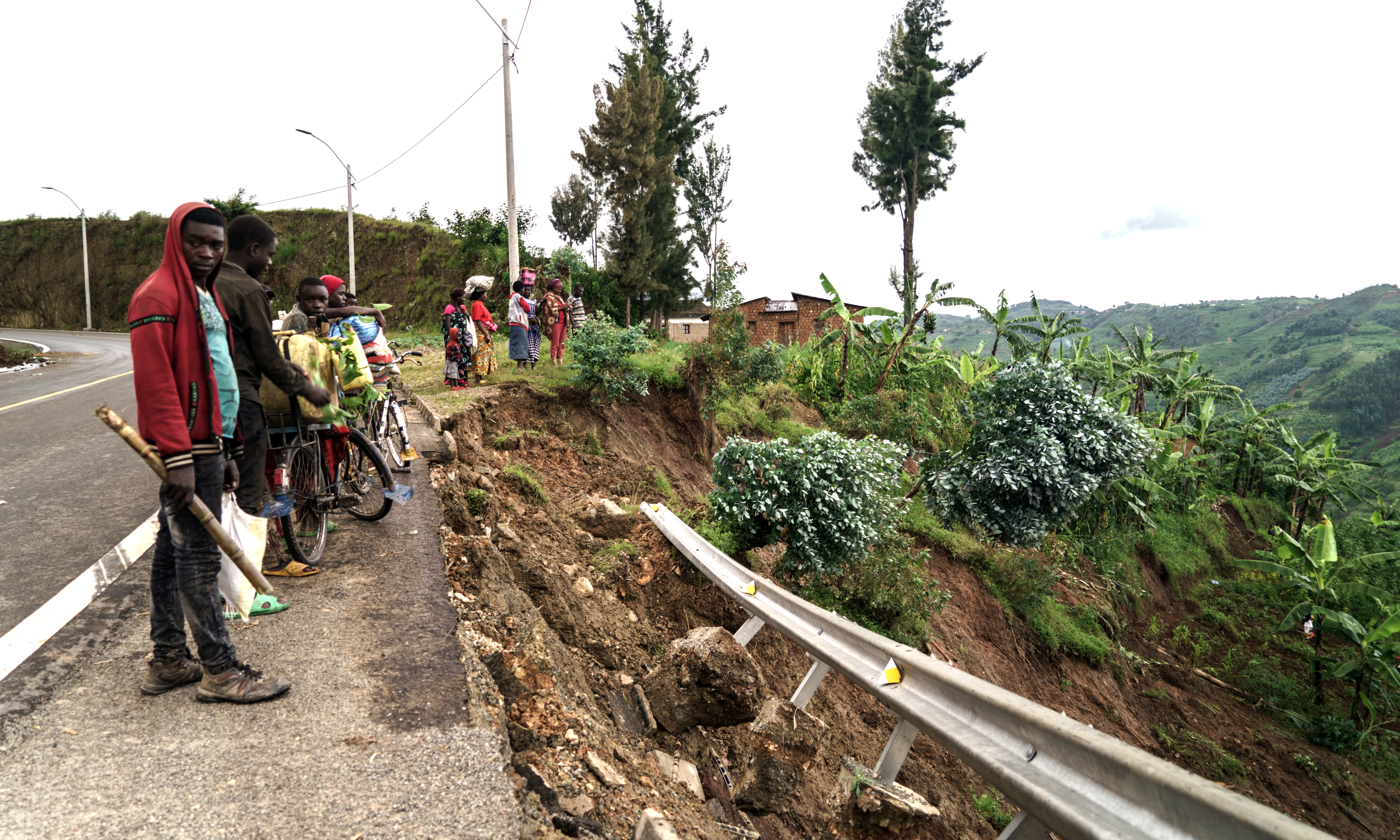 RUBENGERA: Bystanders look at the damaged slope after a landslide caused by heavy rain in Rubengera, Rwanda. At least 130 people have died as floods and landslides engulfed several parts of Rwanda after torrential rains, destroying homes and cutting off roads. – AFP