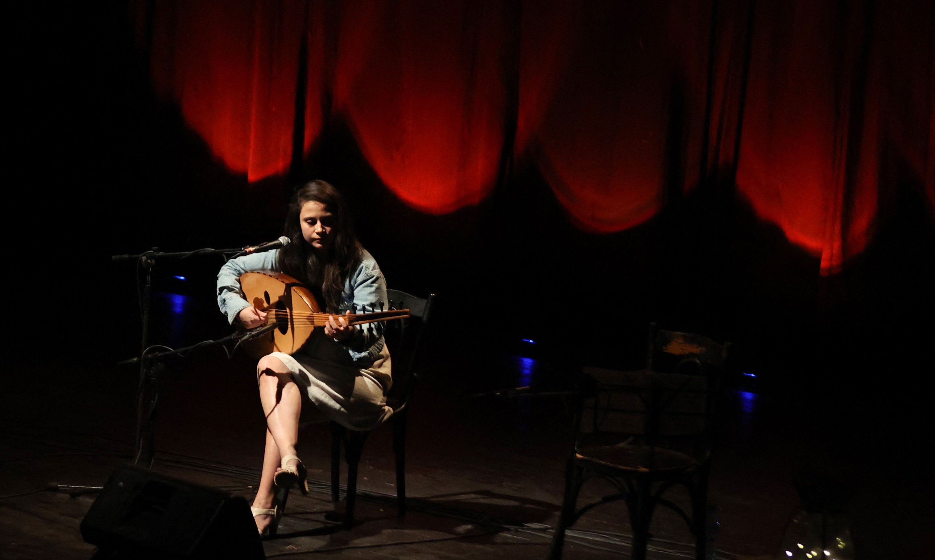 Lebanon's national conservatory of music student Aline Chalvarjian, plays oud (lute) during a concert at the Al-Madina theatre in Beirut.