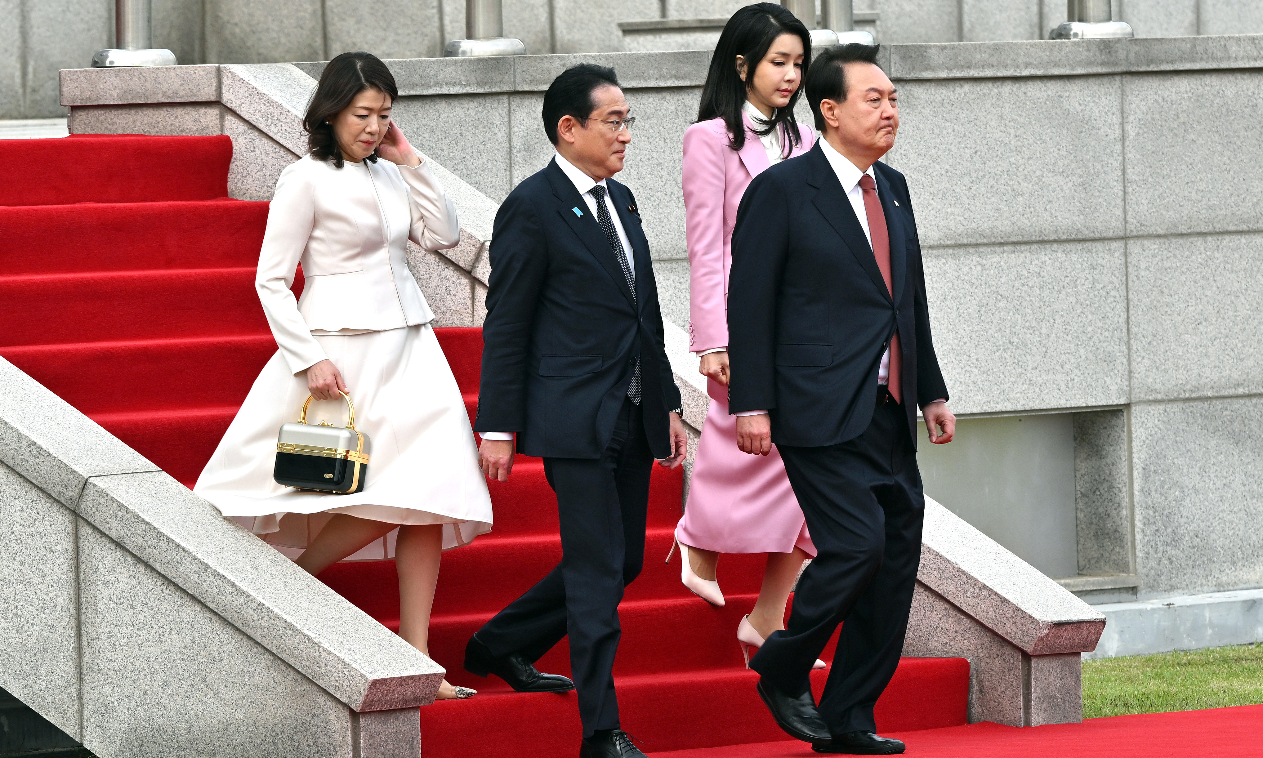 SEOUL: South Korean President Yoon Suk Yeol (right) and his wife Kim Keon-hee (second right) receive Japanese Prime Minister Fumio Kishida (second left) and his wife Yuko Kishida (left) during a welcoming ceremony at the presidential office in Seoul on May 7, 2023. -- AFP