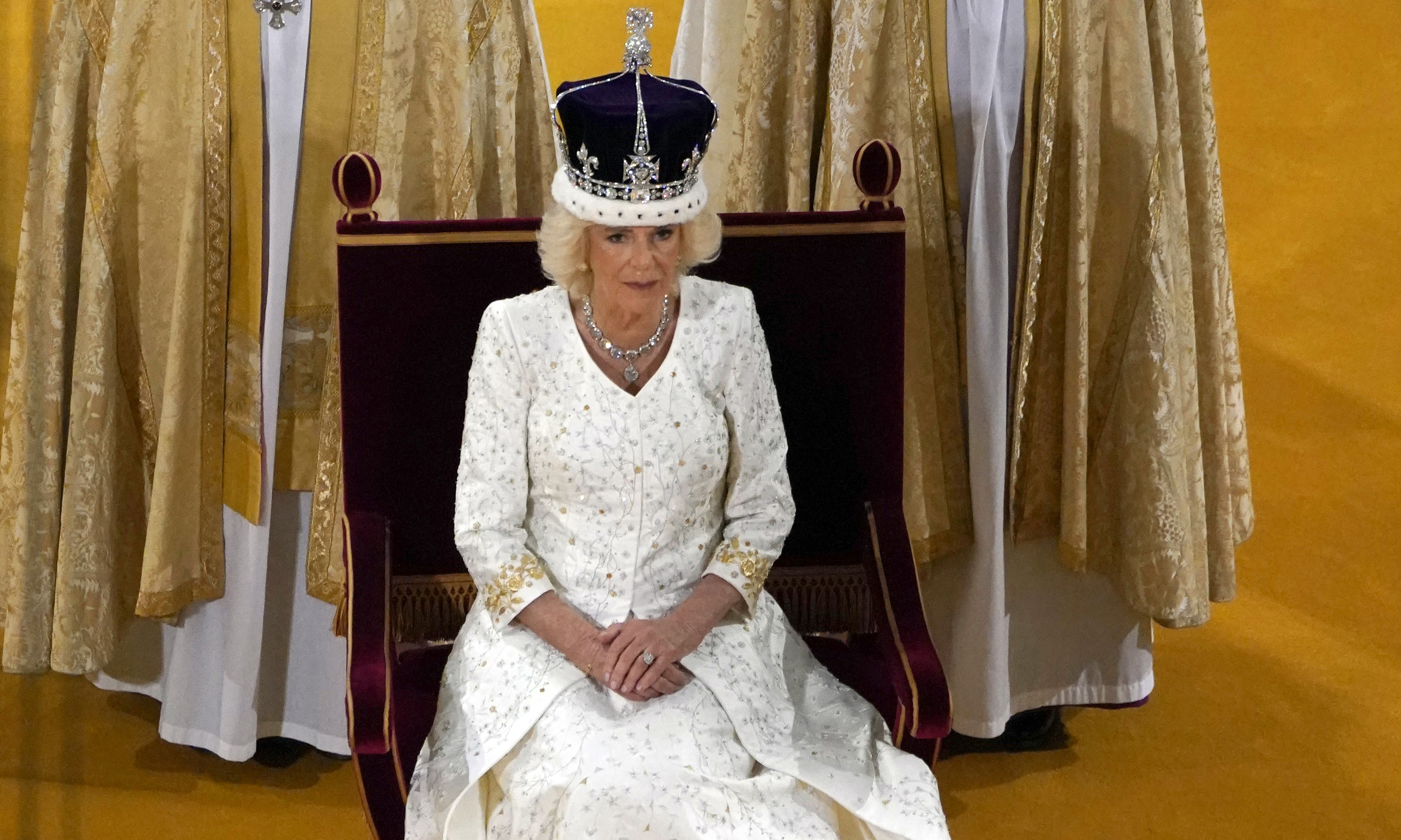 Britain's Camilla sits on the throne wearing a modified version of Queen Mary's Crown during the Coronation Ceremony inside Westminster Abbey in central London.