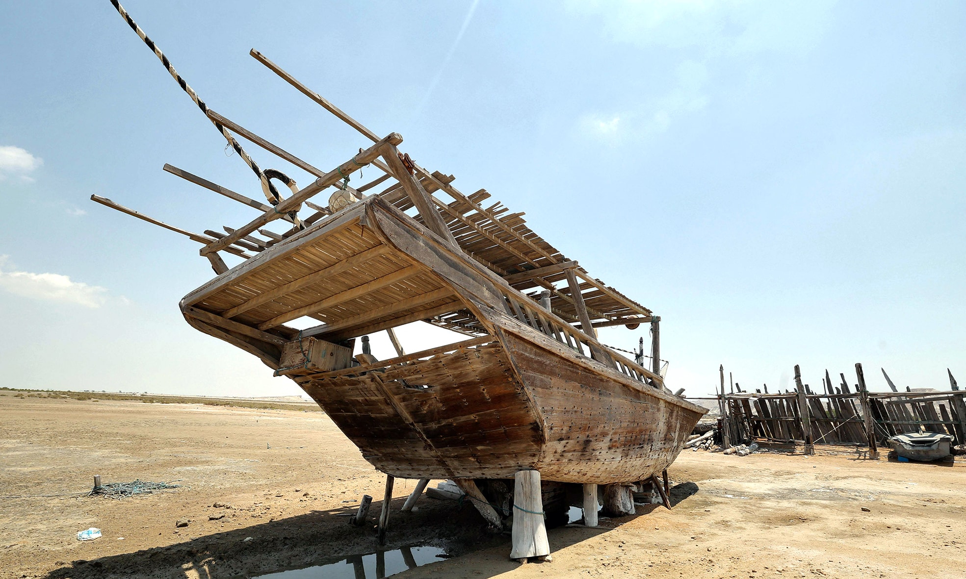 A traditional wooden ship (lenj) is laid ashore for restoration,  in Iran's touristic Qeshm island.