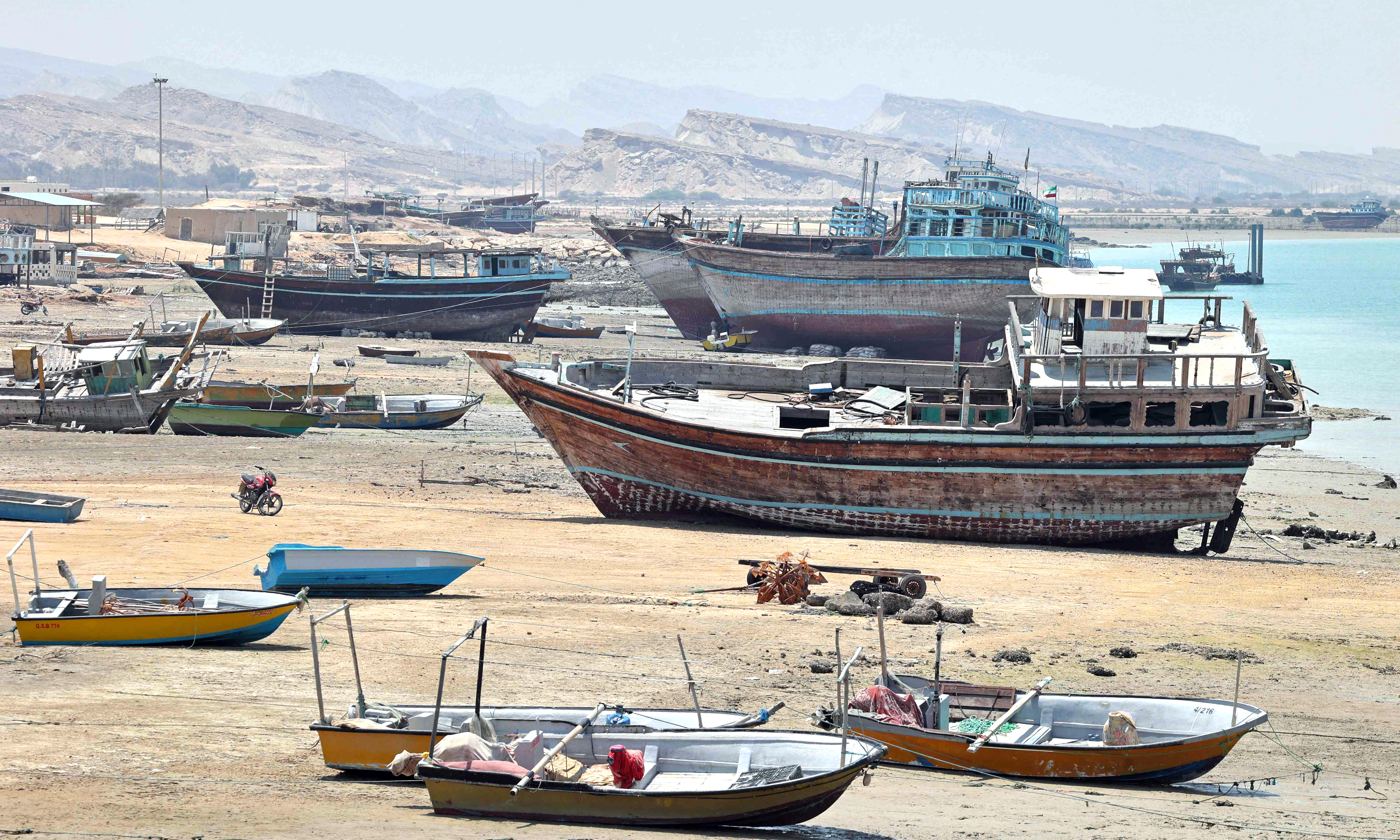 Traditional wooden ships (lenj) are laid ashore for restoration,  in Iran's touristic Qeshm island.