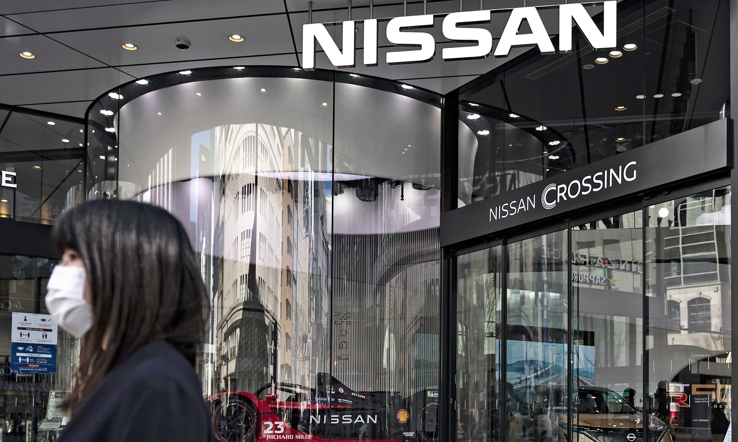 TOKYO: File photo shows a woman standing in front of the Nissan showroom in the Ginza district of Tokyo. Nissan said on May 11, 2023 its full-year net profit slightly topped its estimate and offered an upbeat forecast for the fiscal year ahead. – AFP