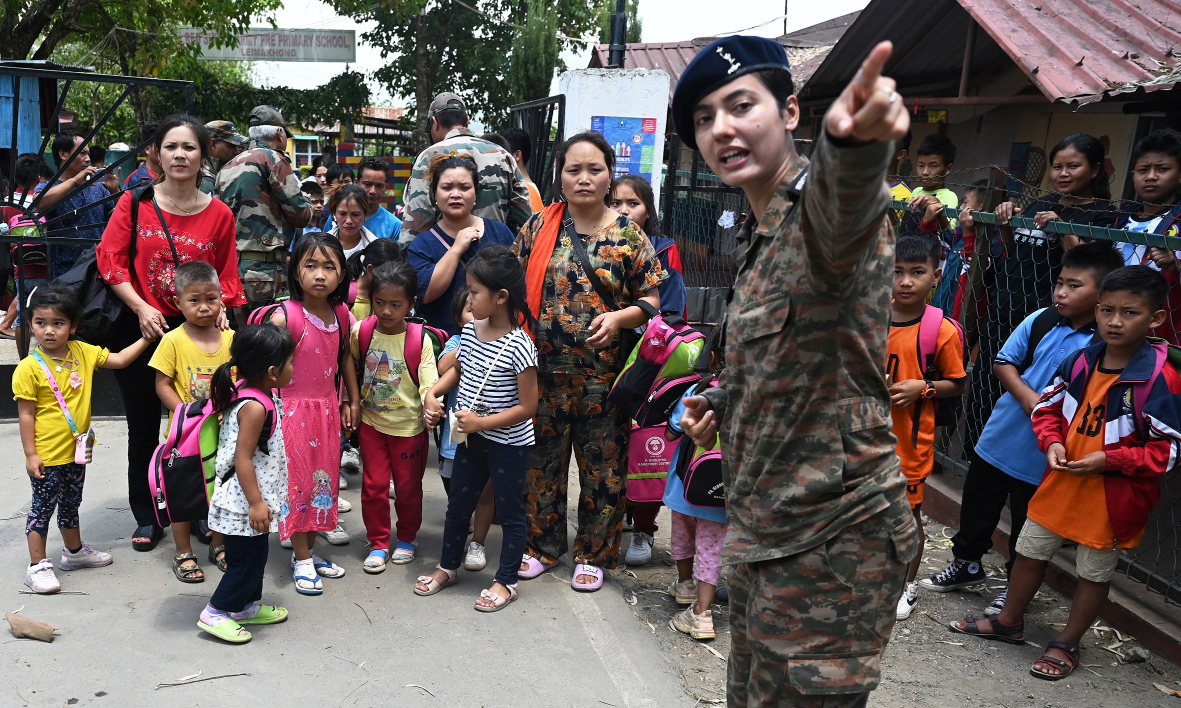 MANIPUR: An Indian army personnel gestures as children evacuated by the Indian army during the ethnic riots in Manipur state prepare to leave after reuniting with their parents at a temporary shelter at the Leimakhong Army Cantonment in the northeastern Indian state of Manipur on May 10, 2023. – AFP