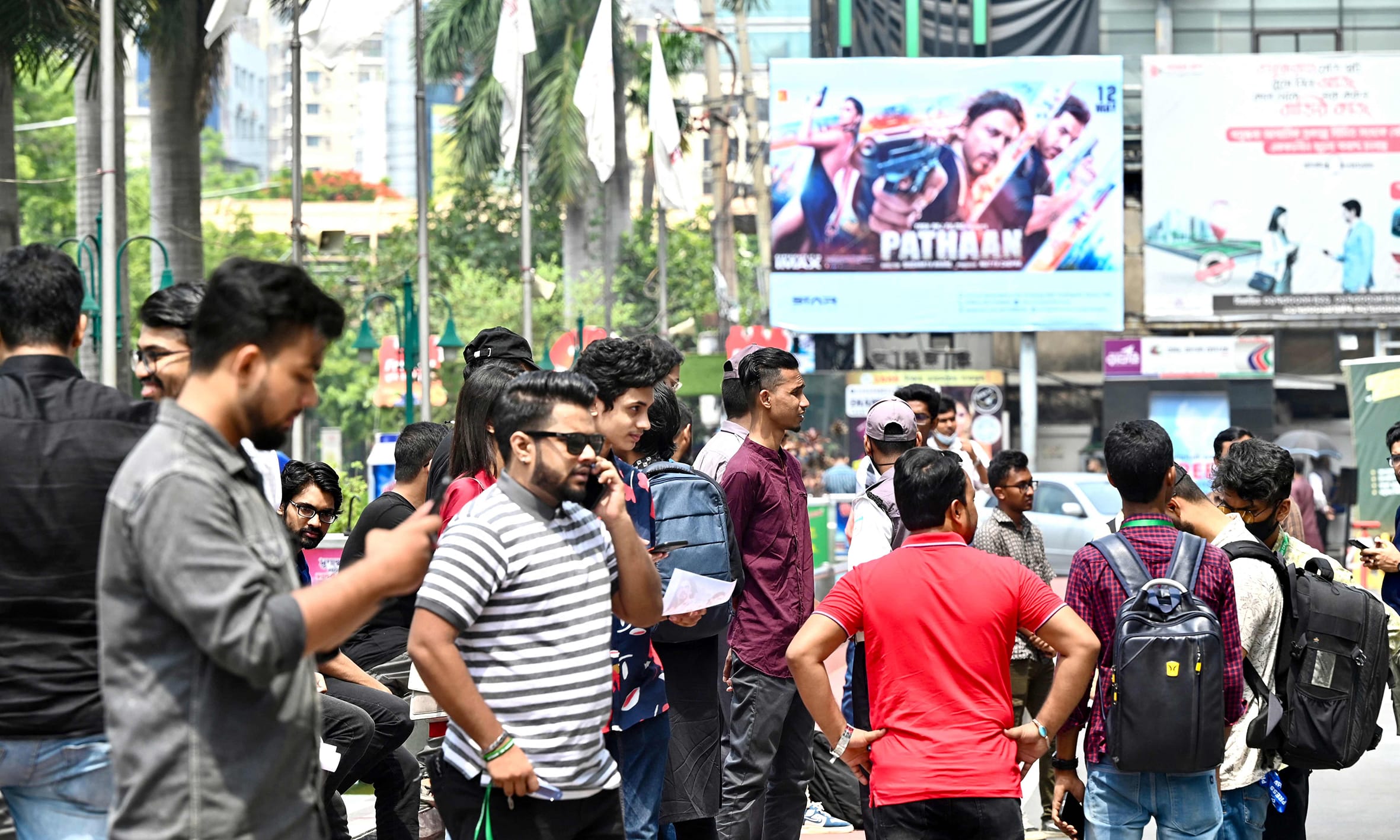 People arrive at a cinema hall to watch Bollywood movie Pathaan in Dhaka.