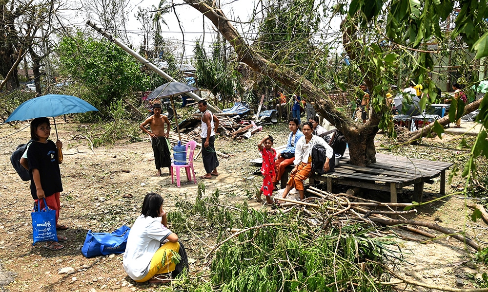 PONNAGYUN: People wait for a car near Ponnagyun Township in Sittwe district Myanmar’s Rakhine state on May 15, 2023, as they plan to return to Sittwe after cyclone Mocha made landfall. — AFP