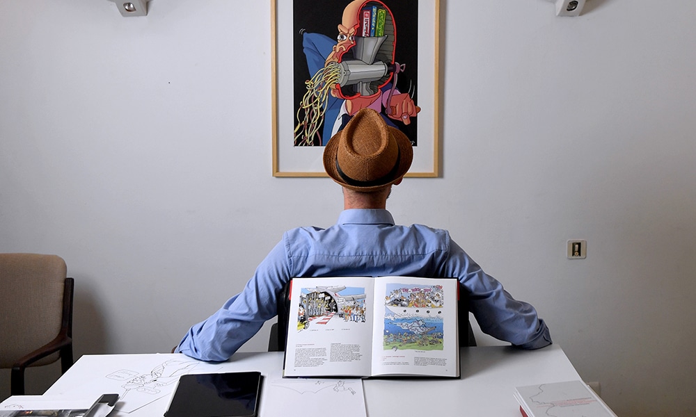 In this image Tunisian architect turned cartoonist known only by the initial 'Z' to protect his anonymity, is pictured in his office in Tunis.--AFP