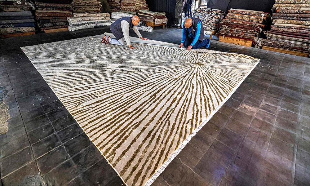 A rug is trimmed at the Kahhal looms hand-made rugs workshop in the Basatin district of Cairo.