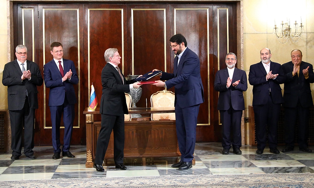 TEHRAN: Iranian Road Maintenance &amp; Transportation Organization Minister Mehrdad Bazrpash (right) and his Russian counterpart Vitaly Savelyev exchanging documents after signing an agreement to construct the final part in the International North–South Transport Corridor (INSTC) in Tehran on May 17, 2023. --AFP
