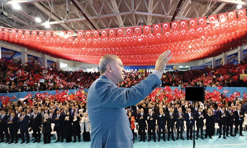 ANKARA: Turkish President Recep Tayyip Erdogan greets the audience as he attends a meeting of non-governmental organizations (NGO) and mukhtars at Taha Akgul Sports Hall on May 24, 2023. – AFP