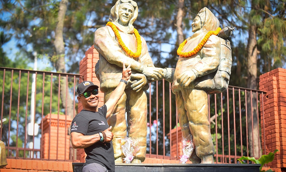 Double-amputee climber Hari Budha Magar poses for pictures in front of the statues of Tenzing Norgay and Edmund Hillary to mark the 16th International Everest Day.