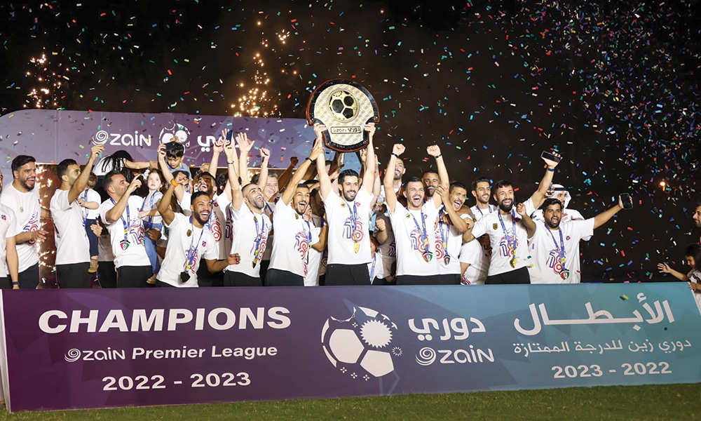 Kuwait SC players celebrate their historic title.