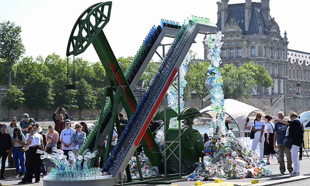 PARIS: Guests stand next to Canadian artist and activist Benjamin Von Wong’s 5-meter tall art installation the “Perpetual Plastic Machine” during its unveiling ceremony on the banks of the Seine River in Paris for the Global Plastics Treaty to stop runaway plastic and use. – AFP