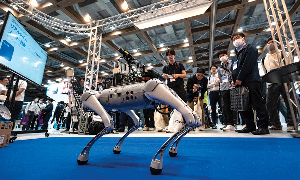 TOKYO: Visitors watch a demonstration of a Unitree Go1 robot dog at a booth by Japanese AI company Automagi during the three-day 7th AI Expo, part of NexTech Week Tokyo 2023, Japan’s largest trade show for artificial intelligence technology companies, at Tokyo Big Sight.- AFP