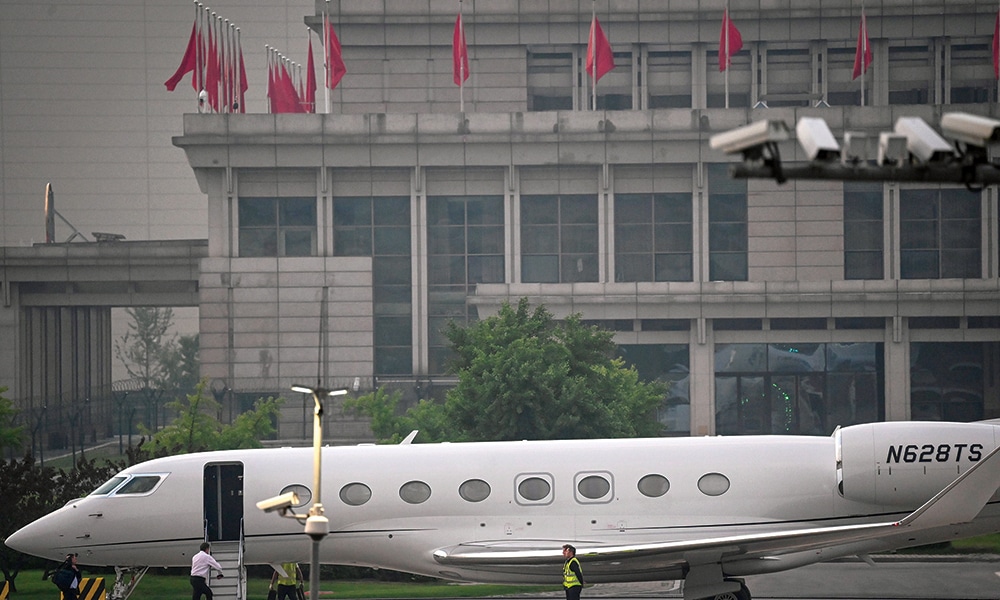 BEIJING: Tesla Chief Executive Officer Elon Musk (in white) boards his private jet before departing from Beijing Capital International Airport on May 31, 2023. – AFP