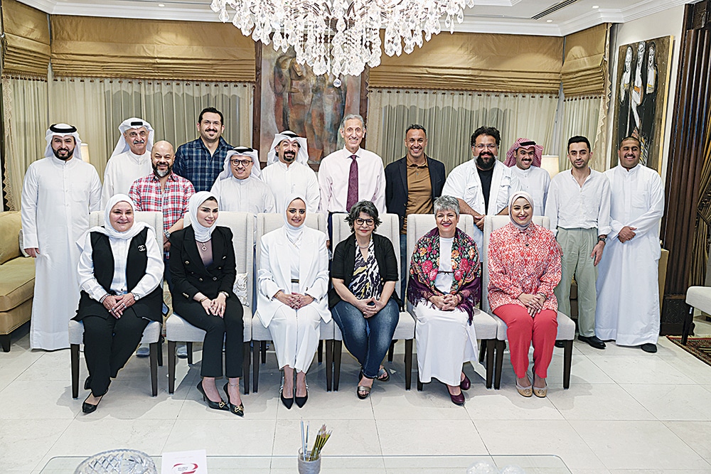 KUWAIT: Writer Taleb Al-Refai (center back) poses with guests at the 11th cultural forum to discuss television drama in Kuwait held at his home on Sunday. -- Photos by Yasser Al-Zayyat