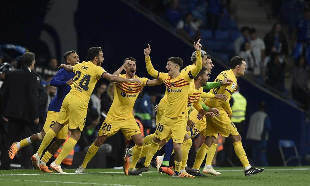 Barcelona's players celebrate winning their 27th Spanish league championship after the Spanish league football match between RCD Espanyol and FC Barcelona at the RCDE Stadium in Cornella de Llobregat on May 14, 2023.